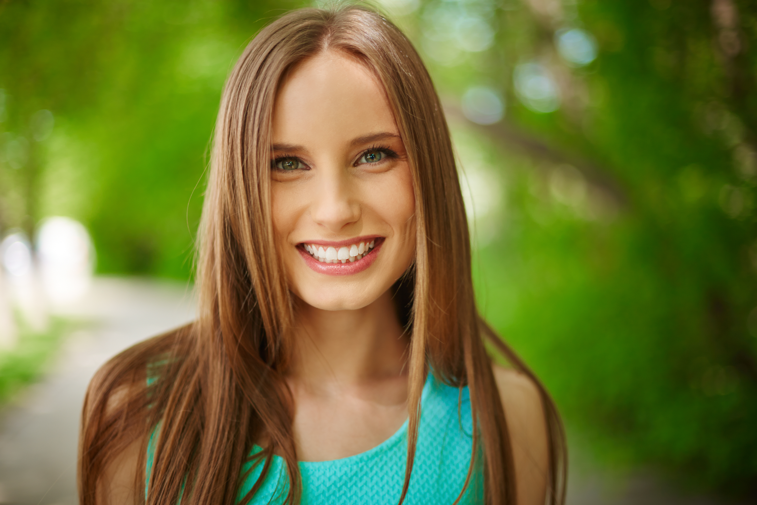 Portrait of smiling girl looking at camera outdoors